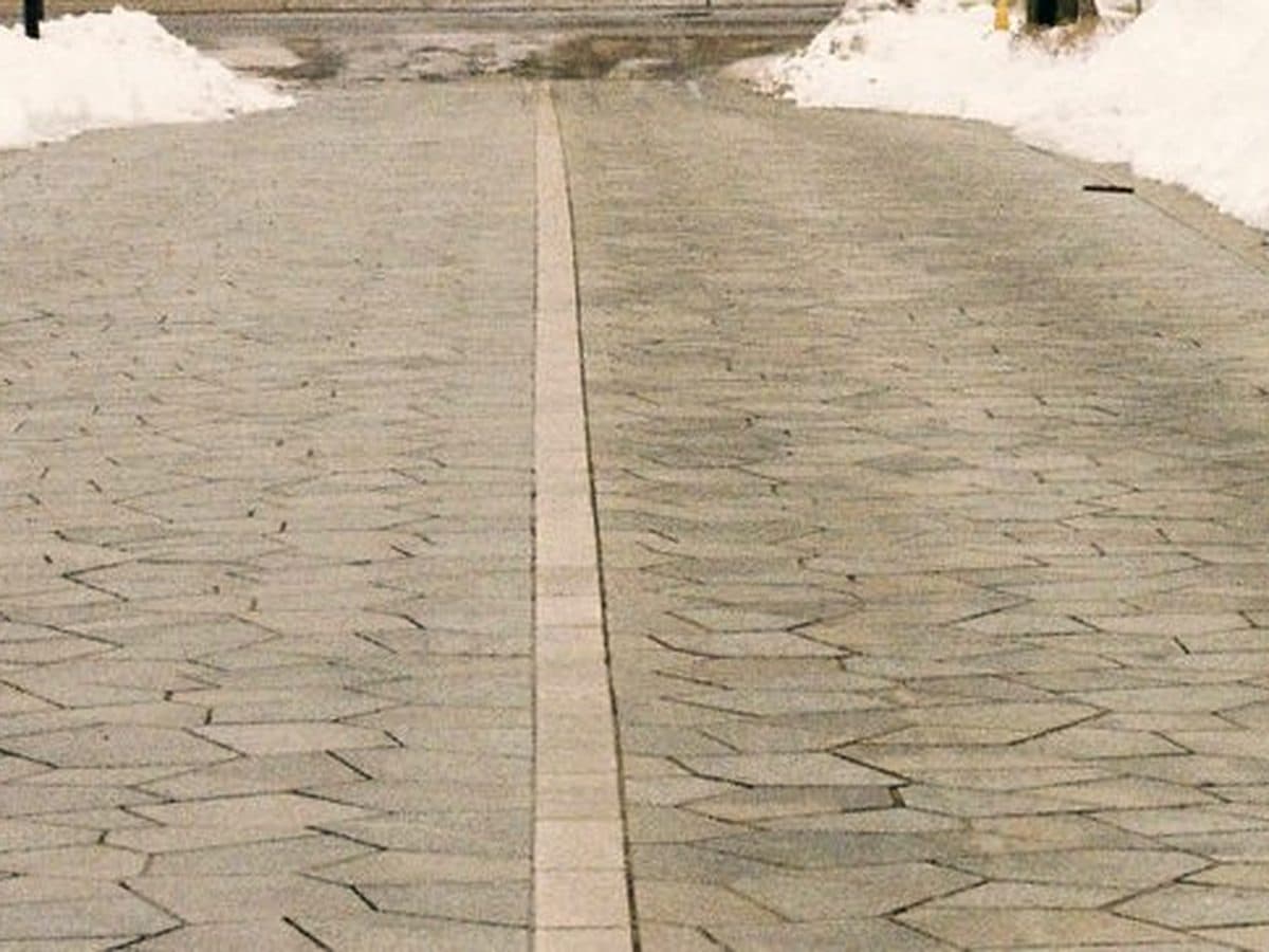 Cleared pavement between banks of snow after winter service